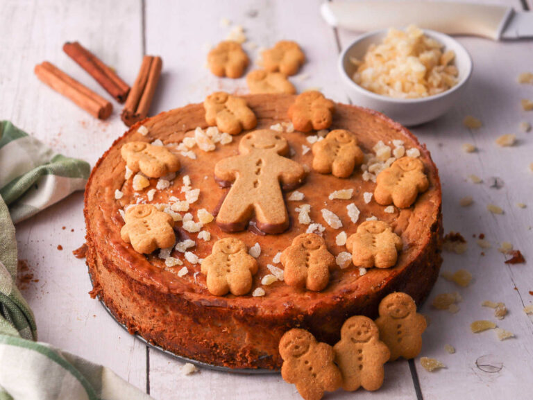 Whole Gingerbread Peanut Butter Cheesecake decorated with mini gingerbread cookies and crystallized ginger.