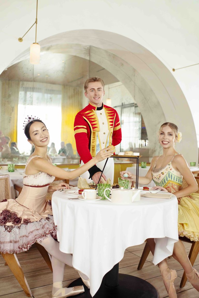 Orlando Ballet dancers in Nutcracker costumes enjoy afternoon tea at a table in ette hotel’s Salt & The Cellar.